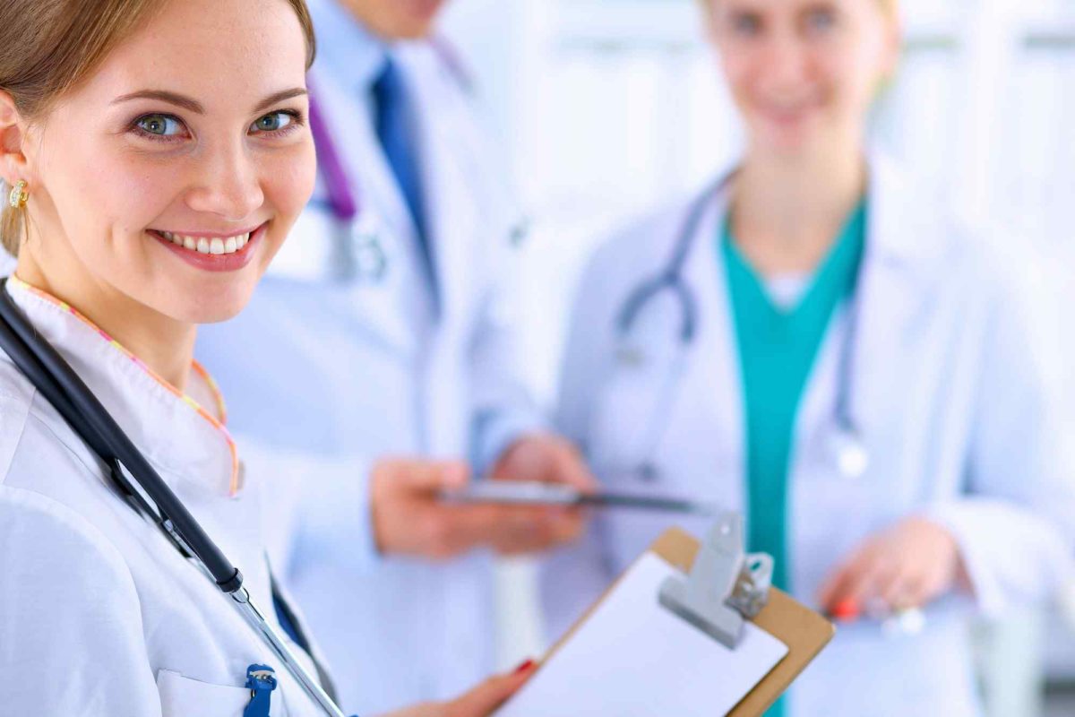smiling woman doctor holding clipboard