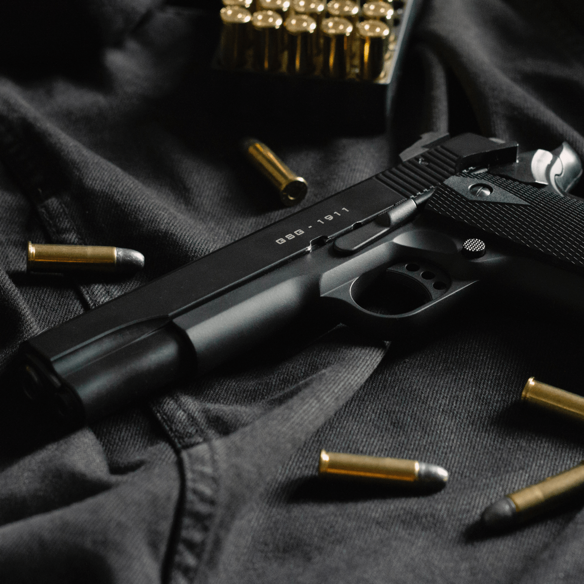 black semi-automatic pistol on black textile