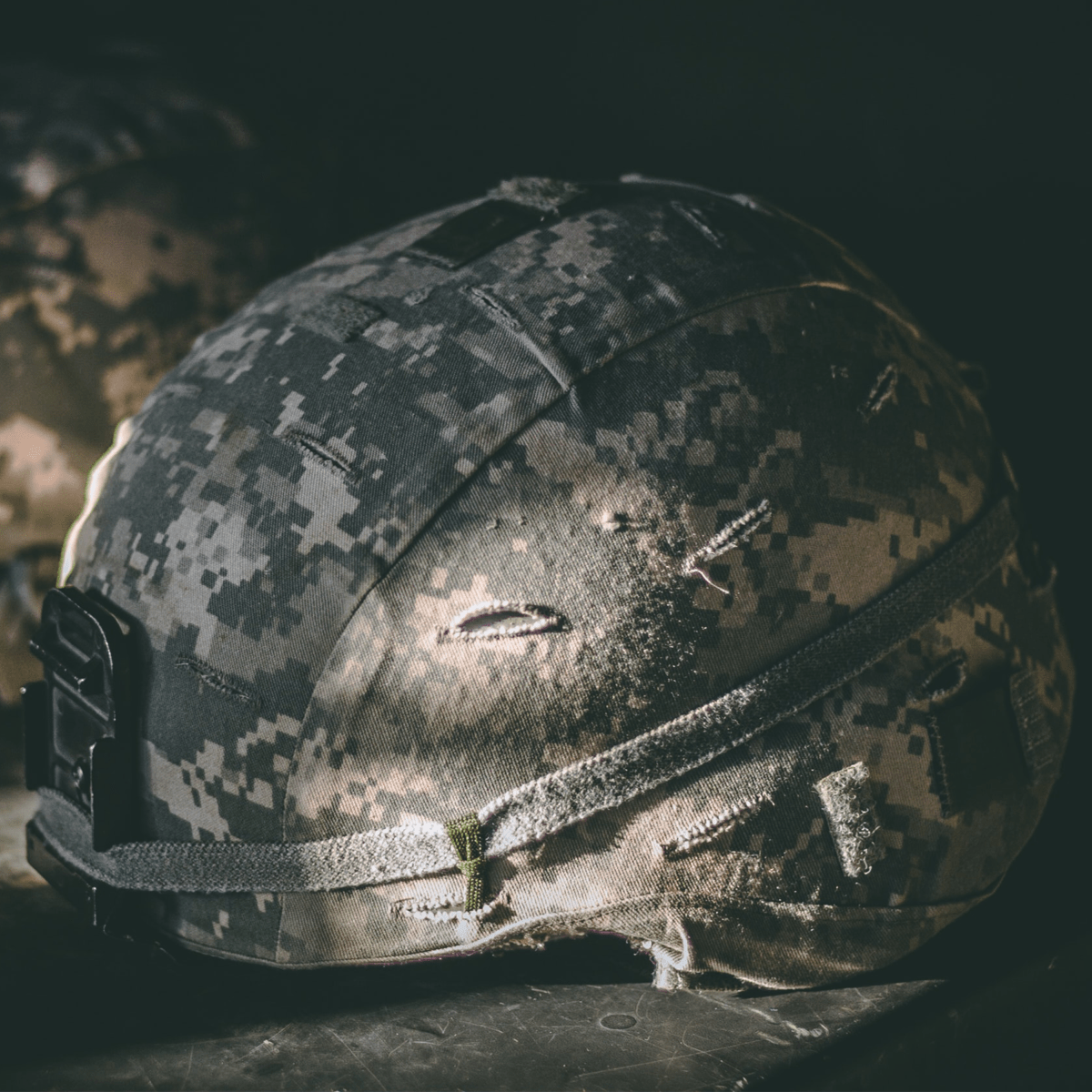 camouflaged soldier helmet on bench