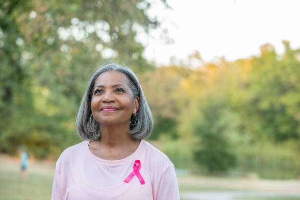 senior woman wearing pink cancer awareness ribbon